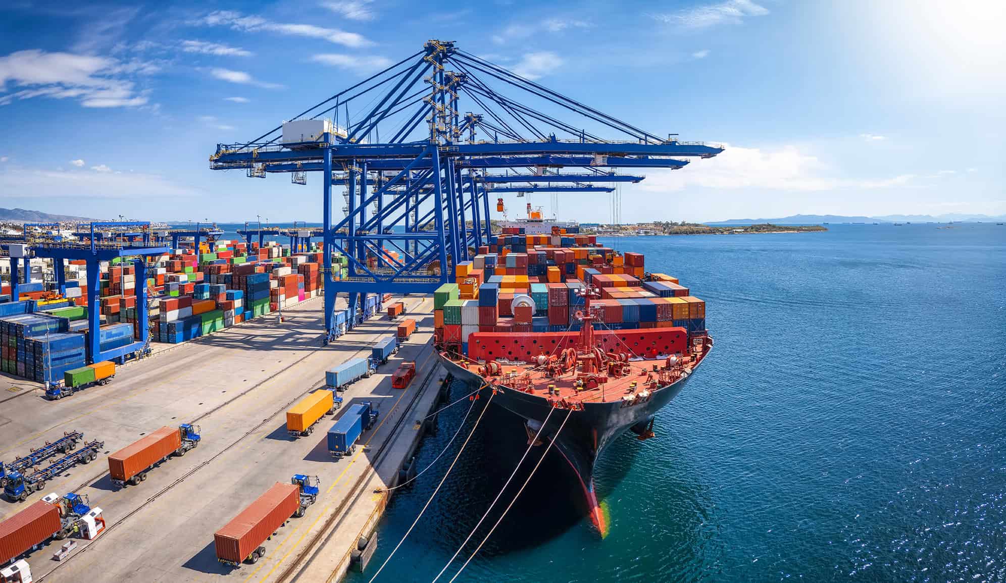 A large container cargo ship is beeing loaded and unloaded in a